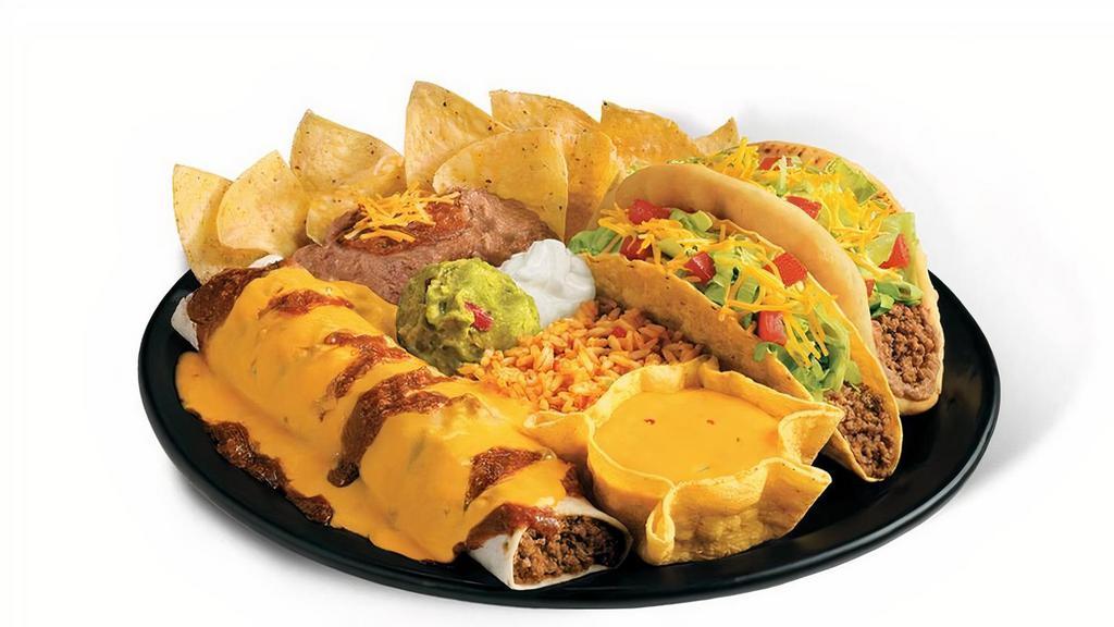 Beef Wholotta Platter · Beef Chilada, Crispy Beef Taco, Beef Muchaco, queso, rice, beans, sour cream, guac, and a small bag of chips.