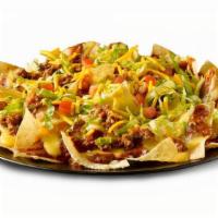 Beef Nacho Salad · Beef, chips, lettuce, chili sauce, queso, tomato.