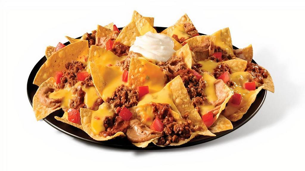 Beef Mucho Nachos · Chips, beef, chili sauce, beans, queso, tomato, sour cream.