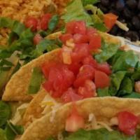 Crispy Tacos Plate · Three tacos. Crispy corn taco shells filled with seasoned ground beef, lettuce, grated chees...