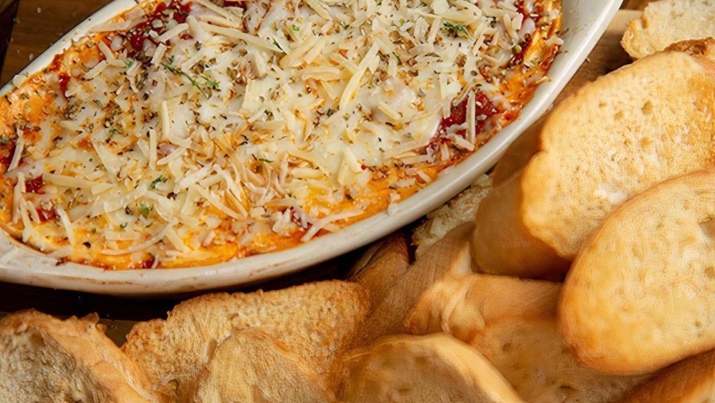 Lasagna Dip · Lasagna captured perfectly in each bite with layers of cheese, beef and Italian sausage. Smothered with Al Dente, topped with mozzarella, and baked to a bubbling finish. Topped with oregano and Parmesan cheese.