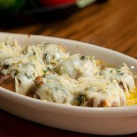 Spin Mushrooms · Fresh mushrooms filled with our creamy spinach dip. Placed in garlic sauce, covered with moz...
