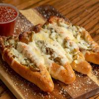 Large Spicy Sticks · Our famous bread sticks with jalapenos and mozzarella cheese. Topped with garlic butter and ...
