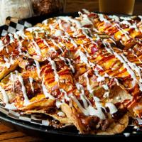 Small Pork Nachos · A LARGE plate of corn chips piled with BBQ Pork, mozzarella cheese, cheddar cheese, onions a...
