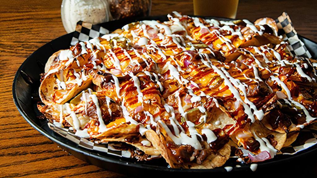 Small Pork Nachos · A LARGE plate of corn chips piled with BBQ Pork, mozzarella cheese, cheddar cheese, onions and jalapenos. Finished off with a drizz' of ranch and BBQ sauce.