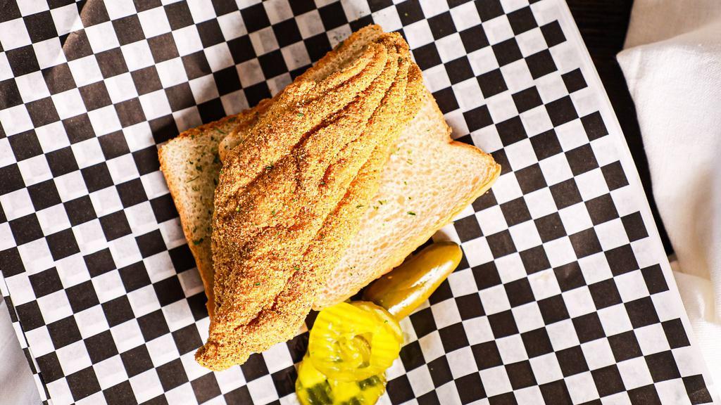 Catfish · Golden Fried Catfish Fillet served on sliced bread with pickles and a jalapeño pepper.