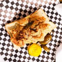 Pork Chop · Golden Fried Thin Pork Chop served on sliced bread with pickles and a jalapeño pepper.