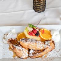 French Toast · Our version of French toast topped with cinnamon-powdered sugar. Served with two poached egg...