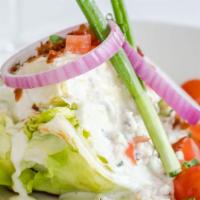 Signature Wedge Salad · Wedge of iceberg lettuce with tomatoes, red onions, scallions, bacon, blue cheese crumbles, ...