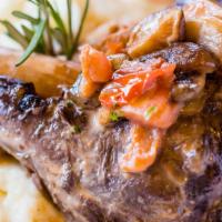 Braised Lamb Shank · 16 oz. Served with garlic whipped potatoes, mushrooms, and sherry wine sauce.