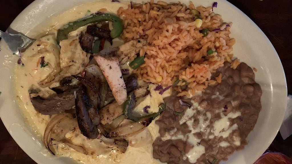 Elsa'S Enchiladas · 3 cheese enchiladas with ranchero sauce. Topped with mixed fajitas. Served with rice and your choice of pinto or black beans.