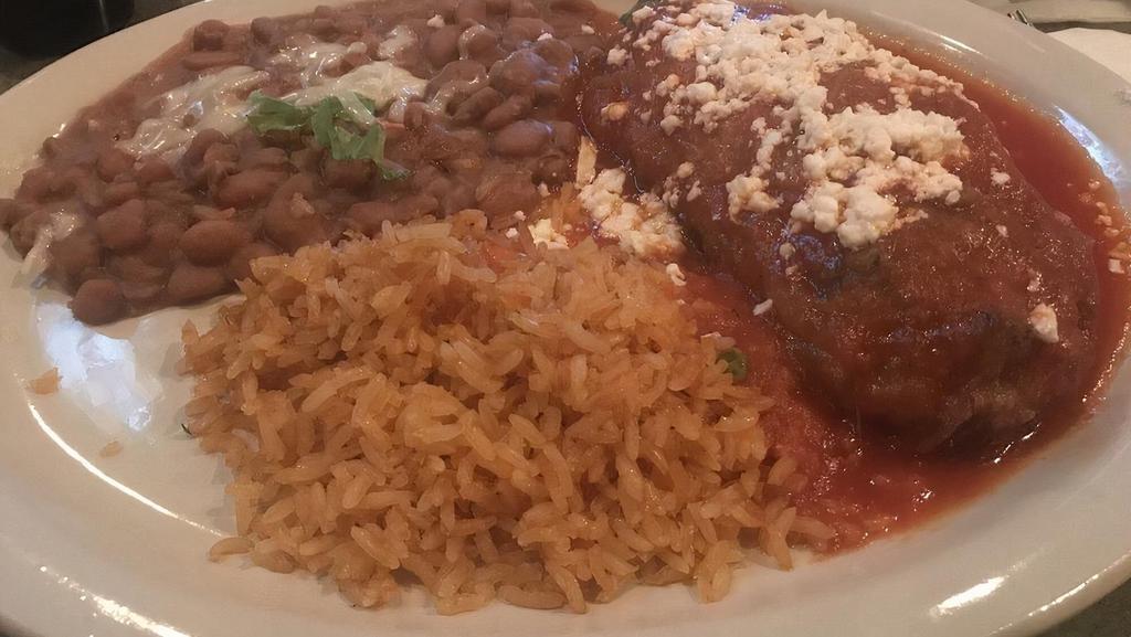 Chile Relleno · Vegetarian. Poblano pepper stuffed with cheese or brisket, battered, fried, and topped with tomato sauce. Served with rice and pinto or black beans.