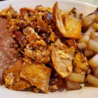 Chilaquiles Plate · Scrambled eggs mixed with bacon, chorizo and crispy tortilla