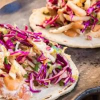 Grilled “Thai” Chicken Taco · Grilled onions, peanut sauce, and red cabbage slaw.