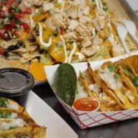 Veggie · All nachos served on house-made corn tortilla chips
with chili con queso, black beans, roast...