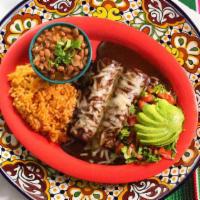 Mole Enchiladas · Two chicken enchiladas topped with mole sauce. Includes Spanish rice, refried or charro bean...