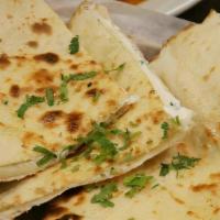 Naan Jalapeno Naan · Fine flower bread infused with mozzarella cheese and jalapeno then baked to perfection.