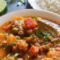 Vegetable  Curry · Traditional homemade curry with a blend of onion and tomato sauce with Indian spices.