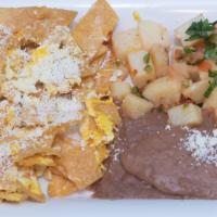 Migas Con Huevo · Two scrambled eggs with tortilla squares and cheese, served with refried beans and seasoned ...