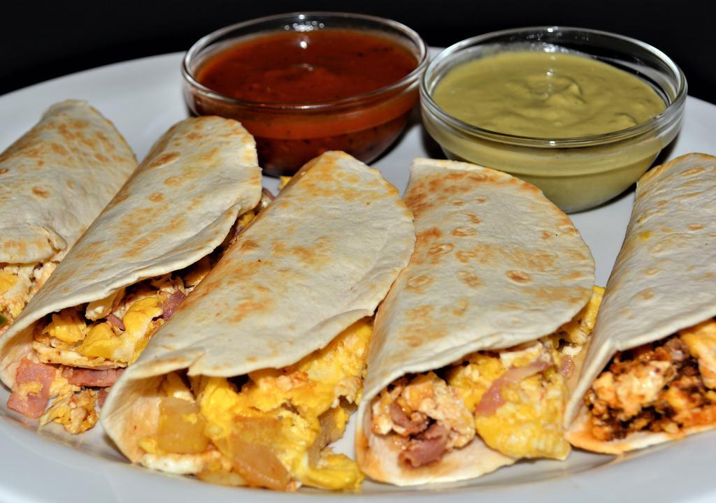Breakfast Tacos · One scrambled egg with your choice of ham, potatoes, sausage, chorizo or a la mexicana in a flour tortilla.
