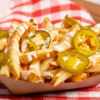 Jalapeno Ranch Fries · French fries drizzled in ranch and topped with jalapeños.