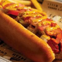 The Works Dog · Grilled hot dog served on a brioche bun, topped with onions, jalapeños, tomatoes, and our wo...