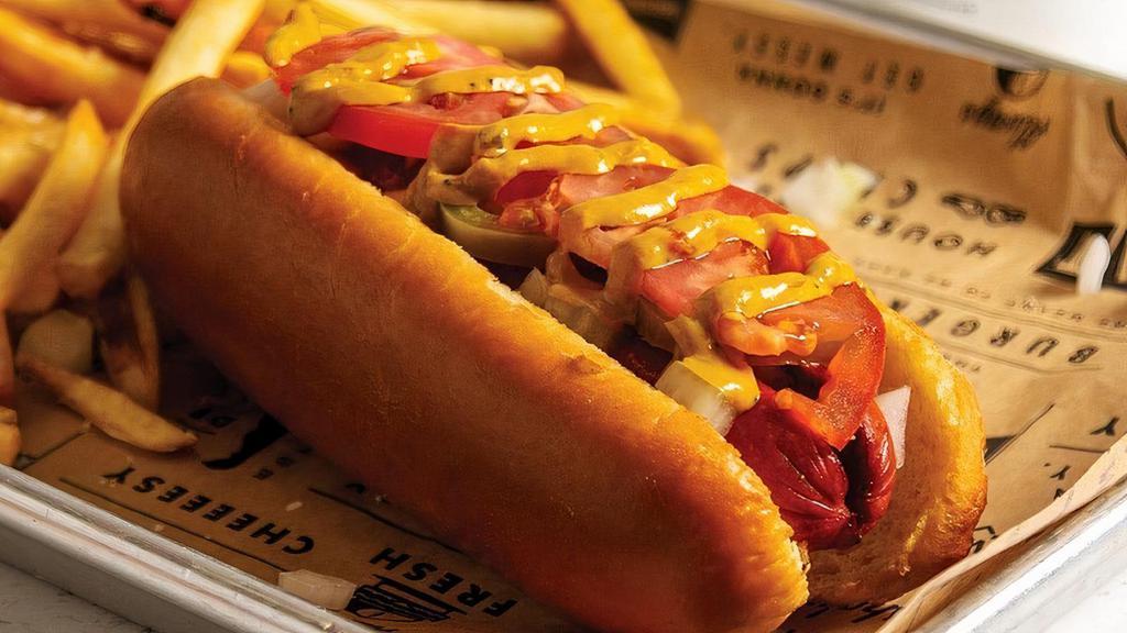 The Works Dog · Grilled hot dog served on a brioche bun, topped with onions, jalapeños, tomatoes, and our works mustard.