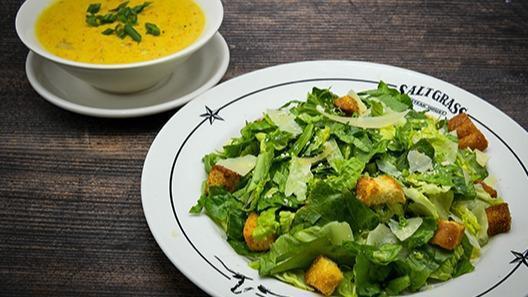 Homemade Soup Of The Day & Salad · Caesar or house salad. Choice of soup includes baked potato soup. Choice of salad includes; house salad with ranch, house salad with honey mustard, house salad with chunky bleu cheese, house salad with Thousand Island, or house salad with balsamic vinaigrette.