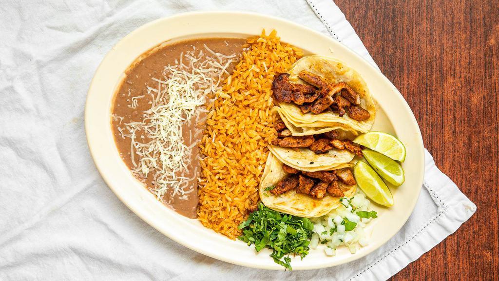 Taco Plate · Three tacos, rice, beans and meat of choice.