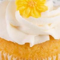 Lemon · Lemon cake topped with  a fresh lemon wedge   and buttercream frosting.