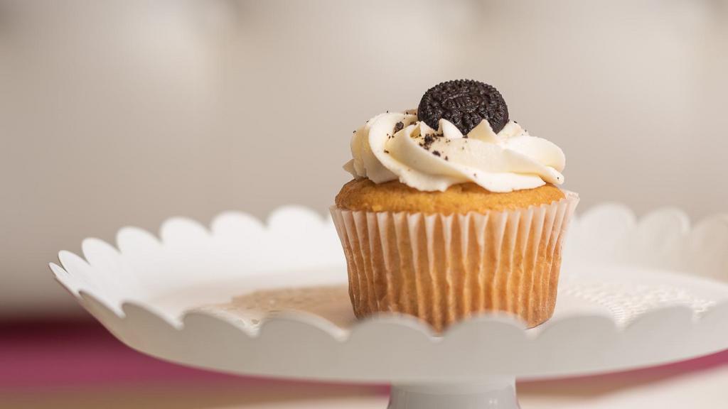 Oreo · Soft vanilla cake with Oreo cookies baked into the batter, topped with buttercream frosting and an Oreo cookie.