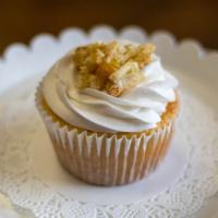 Peach Cobbler Cupcake · Soft peach cupcake stuffed with peach cobbler then topped with buttercream frosting and peac...