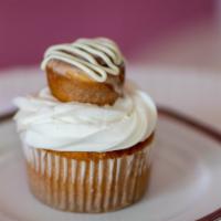 Cinnamon Roll Cupcake · Cinnamon swirl cupcake base topped with a yummy mini cinnamon roll and drizzled with cream c...