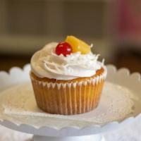 Pina Colada · Moist pineapple cake topped with buttercream icing, sweet coconut, fresh pineapple and a mar...