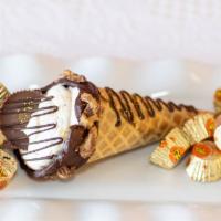 Peanut Butter Cup · Waffle cone dipped in chocolate stuffed with cheesecake with reese's peanutbutter pieces top...