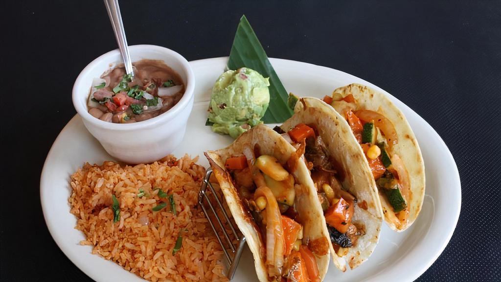 Veggie Tacos · Seasoned fresh sauteed vegetable in corn tortillas with toasted jack cheese. My bueno.