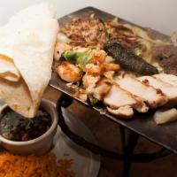 La Gran Parrillada De Guadalajara · Grilled chicken & beef fajita, sautéed shrimp & pork carnitas. Served with borracho beans, r...