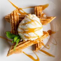 Churros De Cajeta · Warm authentically fried churros filled with caramel sauce, served with vanilla ice-cream fo...