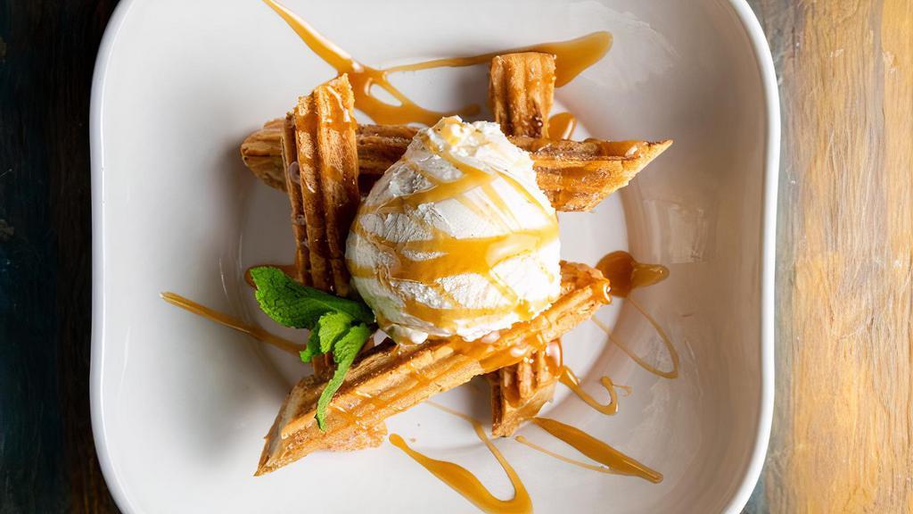 Churros De Cajeta · Warm authentically fried churros filled with caramel sauce, served with vanilla ice-cream for the perfect combination of sweetness.