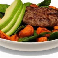 Paleo Burger · Single patty served in a bowl with Diced Sweet Potatoes and Avocado on a bed of Baby Spinach.
