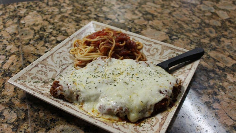 Chicken Parmesan · Lightly breaded chicken breast topped with fresh marinara and mozzarella cheese served with a side of linguini, tossed olive oil, garlic, red pepper flakes and basil.