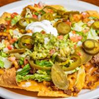 Stadium Nachos · Fresh tortilla chips smothered with re-friend beans, cheese, lettuce, pico De gallo, jalapeñ...