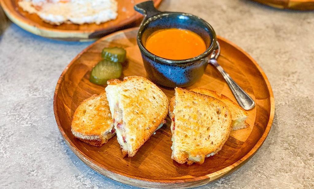 Omg Grilled Cheese · layered gruyere, whipped brie, goat cheese, white cheddar, smoked bacon, creamy tomato soup dip