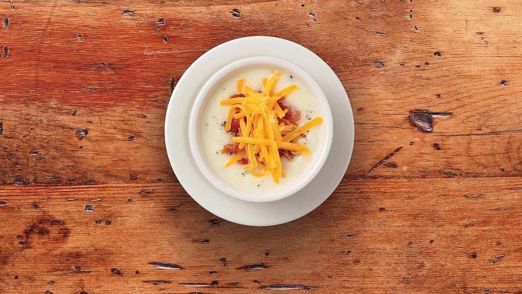 Country Potato Soupe · Our creamy potato soupe accented with leeks and onions. Garnished with cheddar cheese and chopped bacon.