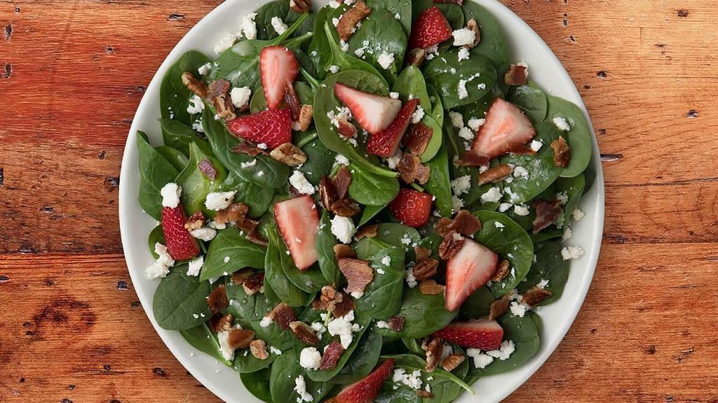 Strawberry Bacon Spinach Salade · It's Back! Spinach salad topped with strawberries, bacon, feta and pecans. Tossed in French vinaigrette!