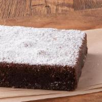 Fudge Brownie · A fudge brownie topped with powdered sugar.