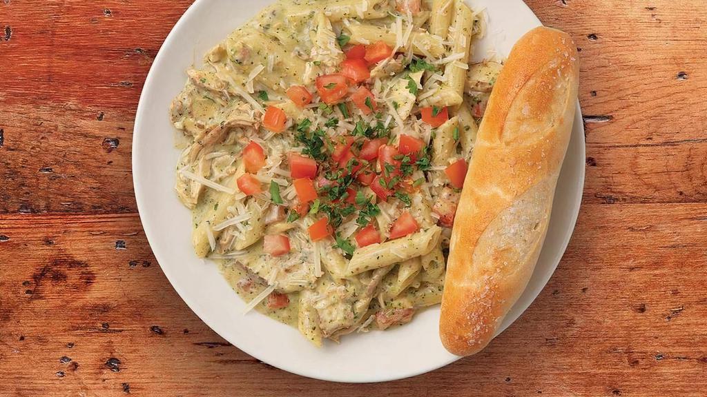 Pesto Pasta (Chicken) · Penne pasta sautéed in our house-made pesto cream sauce with balsamic-marinated chicken and fresh diced tomatoes on top.