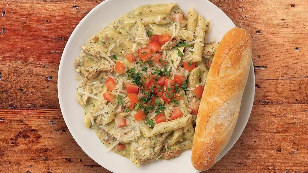 Pesto Pasta · Penne pasta sautéed in our house-made pesto cream sauce topped with fresh diced tomatoes.