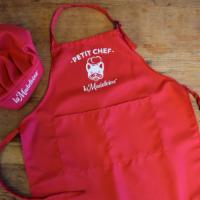 Kid Apron & Hat · A la Madeleine branded chef's hat and apron for your chef-in-training at home.