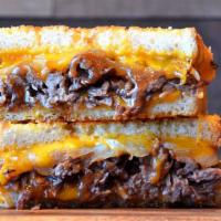 Smoked Brisket Grilled Cheese · Smoky beef brisket, Provolone and cheddar cheese and grilled onions on artisan bread with ga...